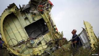 A Malaysian air crash investigator inspects the crash site of Malaysia Airlines Flight MH17, near the village of Hrabove (Grabove), Donetsk, Ukraine on 22 July 2014