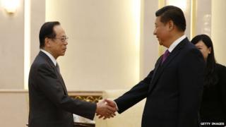 Chinese President Xi Jinping (R) shakes hands with Former Japanese Prime Minister Yasuo Fukuda
