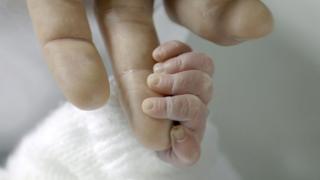 Baby holding mum's hand