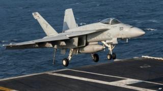 A US Navy aircraft lands on the USS Carl Vinson in the Persian Gulf - 31 October 2014