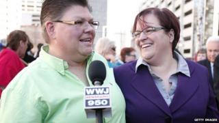 Jayne Rowse (L) and her partner April DeBoer speak with the news media while attending a rally in favor of same-sex marriage at the U.S. Courthouse 16 October 2013