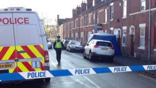 Police and tent outside dead woman's home