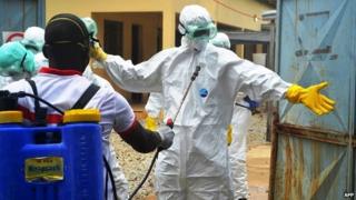 Guinean health workers wearing protective suits at a hospital in Conakry - 14 September 2014