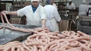 Raw sausages being made