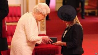 The Queen presents Jane Sutton with Stephen's MBE