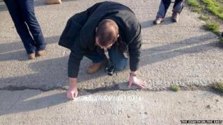 Man covers graffiti in chalk