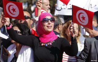 A supporter of Beji Caid Essebsi, Nidaa Tounes party leader and presidential candidate, waves flags and shouts slogans during the opening of his campaign headquarters in Monastir November 2, 2014.