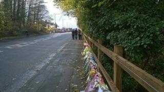 Bunches of flowers at the spot where the teenagers were killed