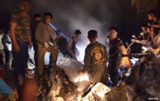Rescue workers recover remains of victims from the site of a helicopter crash in Phayao province November 17, 2014