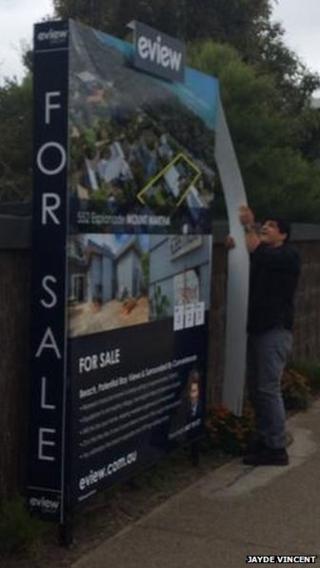 man removing sign