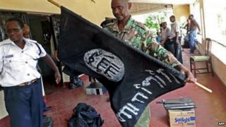 Kenyan policeman with black flag
