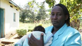 Child welfare worker with rescued baby