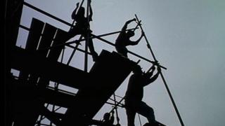Silhouette of builders on construction site