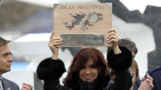 Argentine President Cristina Fernandez de Kirchner holds a plaque before delivering a speech during a ceremony to mark the 30th Anniversary of the 1982 South Atlantic war between Argentina and the Britain over the Falkland Islands