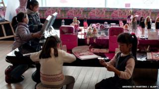Young girls sitting around a table in the Barbie Store in Shanghai in 2009