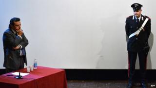 Costa Concordia captain Francesco Schettino (L) stands during his trial in a local theatre in Grosseto on December 2, 2014