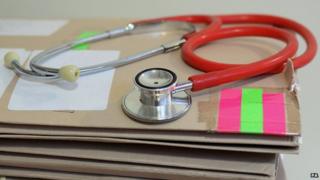 A stethoscope on top of patient's files
