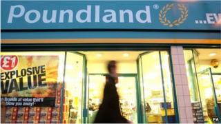 A man walks past a Poundland store