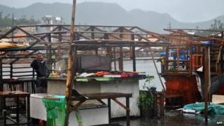 A man repairs his damage house in Tacloban, central Philippines on 7 December 2014