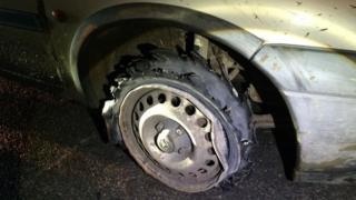 Shredded tyre on van