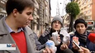 Young Democrats members holding urine samples outside the council building