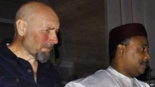 Serge Lazarevic (L) stands next to Niger's President Mahamadou Issoufou after being freed (9 December 2014)