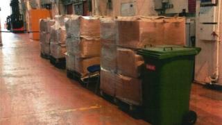A stack of cardboard boxes in a warehouse