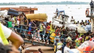 Library picture showing people arriving on in DR Congo a crowded boat from neighbouring Congo Brazzaville, in April 2014.
