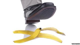 Shoe about to step on a banana skin