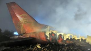 The tail-end wreckage of the Henan Airlines ERJ-190 jet after it slammed into the ground in Yichun, Heilongjiang province, on 25 August 2010