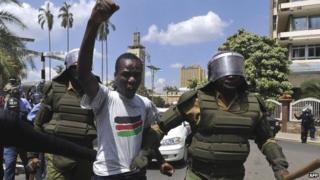 Policemen arrest a man protesting against controversial new security legislation in Nairobi, Kenya - 18 December 2014