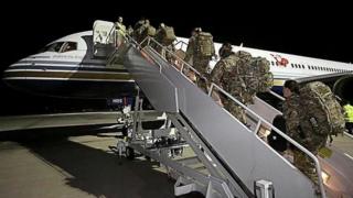 Reservists board flight