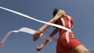 Female athlete crosses finishing line