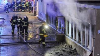 Firemen outside the mosque in Eskilstuna, Sweden, that was set alight - 25 December 2014
