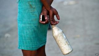 An Indian man after defecating in the open