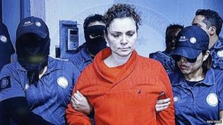 Maria de los Angeles Pineda Villa, the wife of the former mayor of Iguala, Jose Luis Abarca, as seen displayed on a television screen during a news conference, while she is transferred to a high security jail.