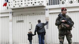 Soldier standing guard outside a Jewish school in Paris, 12 January 2015