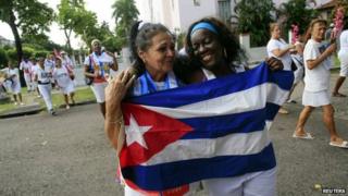 Recently released dissidents Aide Gallardo (left) and Sonia Garro hold the Cuban national flag during a march in Havana on 11 January, 2015.