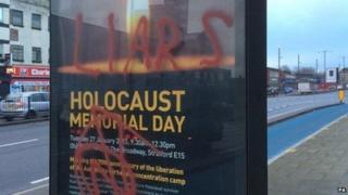 Posters advertising a Holocaust memorial event in east London have been daubed with graffiti including the words "liars" and "killer"