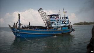 In this picture taken on 3 December 2014, Myanmar national and migrant workers on a fishing boat in Ban Nam Khaem village in Chiang Mai, Thailand.
