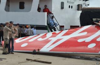 Investigators examine the tail of AirAsia flight QZ8501 in Kumai, 12 January