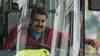 Venezuelan President Nicolas Maduro drives a bus while leaving the airport after arriving in Caracas on 17 January, 2015