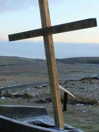 A wooden cross was left in place of the statue