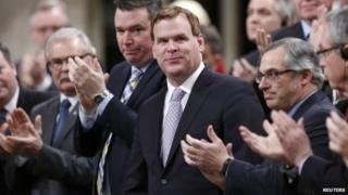 Canada"s Foreign Minister John Baird (C) receives a standing ovation before announcing his resignation in the House of Commons on Parliament Hill in Ottawa 3 Februay 2015