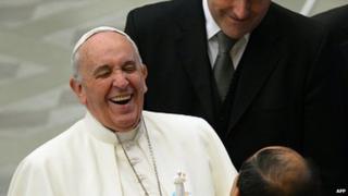 Pope Francis laughs as he meets with newly married couples at the end of his weekly general audience at the Paul VI hall on January 28, 2015 at the Vatican.