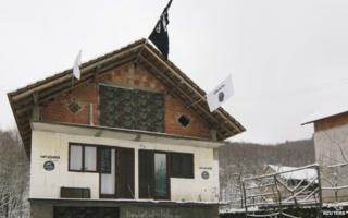 A house in the Bosnian village of Gornja Maoca decorated with Islamic State flags, January 26, 2015