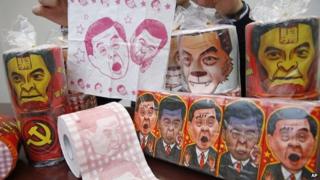 Rolls of toilet paper and packages of tissue paper printed with images of Hong Kong Chief Executive CY Leung are shown by Hong Kong Democratic Party Vice Chairman Lo Kin-hei at his office in Hong Kong, 7 February 2015