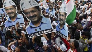 Supporters of Aam Aadmi (Common Man) Party (AAP) hold portraits of Arvind Kejriwal, during celebrations outside their party office in Delhi February 10, 2015