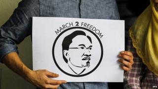 Family members of Malaysian opposition leader Anwar Ibrahim hold a placard during a press conference about the "March To Freedom" campaign in Segambut, Kuala Lumpur, Malaysia, on 11 February 2015