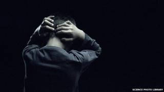 Boy holding his head